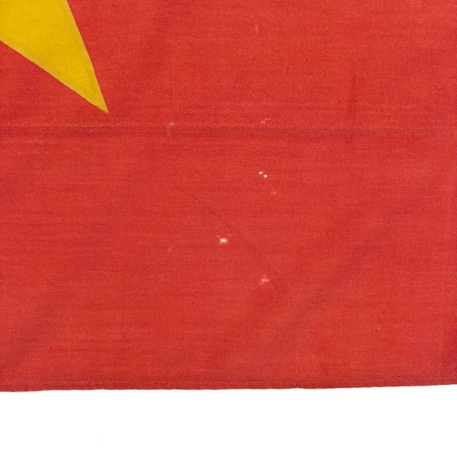 This vintage Vietnamese flag is made from a wool cloth in faded orange-red, with printed design visible on both sides....