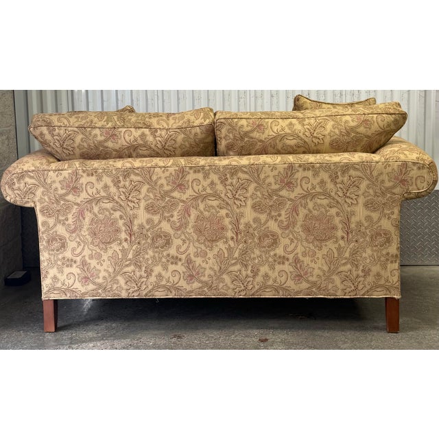Beautiful two seat loveseat by Ethan Allen. Features an intricate floral damask upholstery, rolled arms, loose back and...