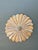 This vintage carved wood sunburst wall medallion is a sculptural decorative accent with a strong mid-century presence....