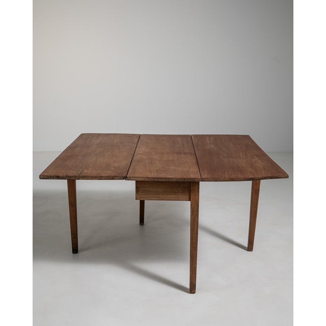 A traditional Swedish drop-leaf “slagbord” table designed for compact living, commonly used in Scandinavian homes. The...