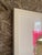 Mixed media collage on canvas, in a white wood floater frame with a bevel cut mat. Full frame dimensions measure 21 x 18 x 1.