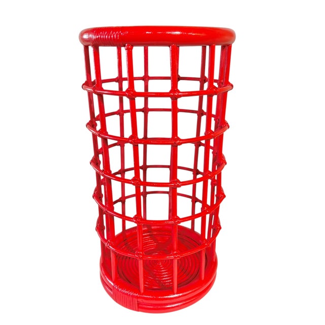A vintage mid century bamboo stick or umbrella stand that has been painted in a shiny raspberry red color. This stand was...