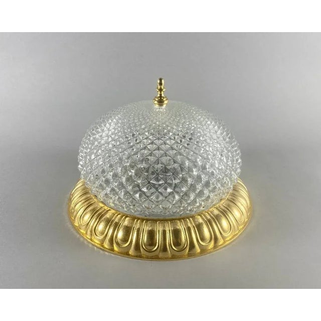 Luxurious vintage ceiling lamp. Gold-plated glass shade and matching gilded bronze frame. the ceiling lamp is a real...