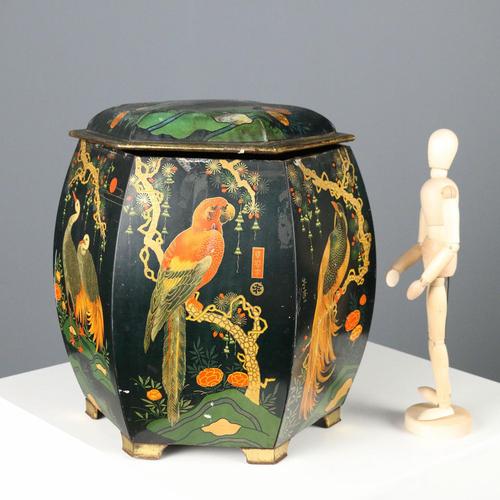 Tin box with polychrome chinoiserie decoration on a black background depicting birds, lanterns, branches, and plant...