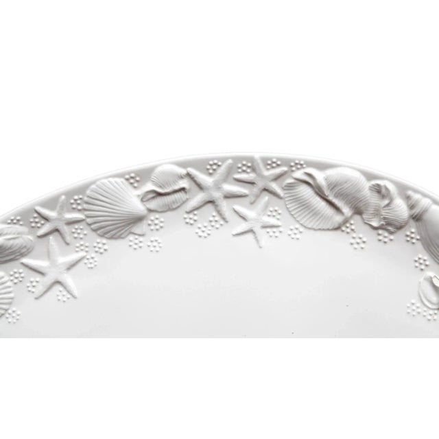 Large Italian ceramic serving platter featuring an embossed sealife motif. Glossy white finish.