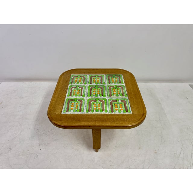 A solid oak occasional table with inset ceramic tile top by Guillerme et Chambron for Votre Maison, France, circa...