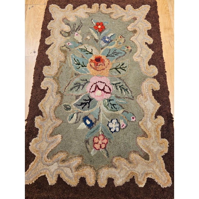 This charming early American hand-hooked rug was crafted in the early 1900s in the New England tradition � one of the...