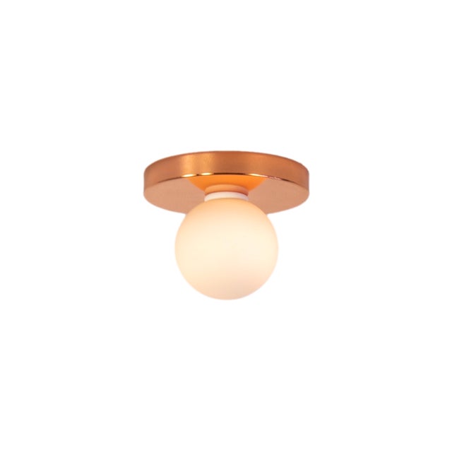 Minimal from top to bottom. This black flush mount pairs a metal base with a soft glass globe. Cool, calm, and quietly...