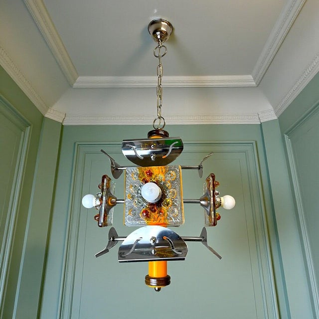 This chandelier has been restored to its original beauty. It is made of metal painted orange and equipped with four E14...