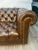 A lovely traditional style chocolate brown leather English chesterfield sofa on casters. Perfect for an office or study....