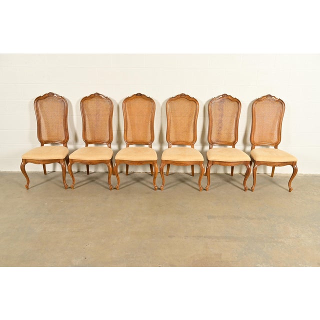 A gorgeous set of six French Provincial Louis XV style dining chairs By Thomasville USA, Circa 1960s Sculpted walnut...
