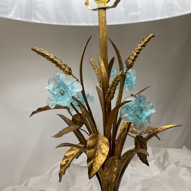 A refined pair of vintage table lamps crafted in patinated bronze and accented with decorative floral elements. Each lamp...
