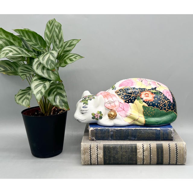 Gorgeous, ceramic sleeping cat by Andrea by Sadek, beautifully decorated in a vibrant tobacco leaf pattern with pink...