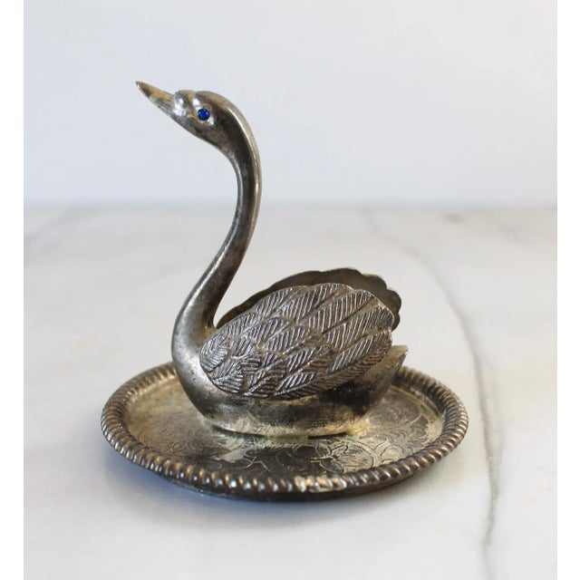 Vintage silver-plated metal swan ring holder and trinket dish, featuring an embossed floral design with a roped edge on...