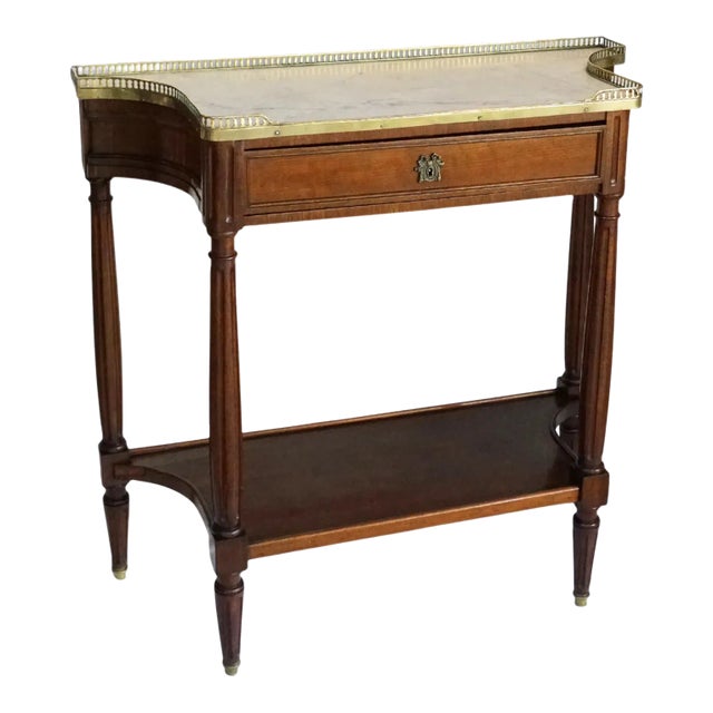 This French Louis XVI style server is crafted from mahogany and topped with a beautiful slab of Carrara marble, framed by...