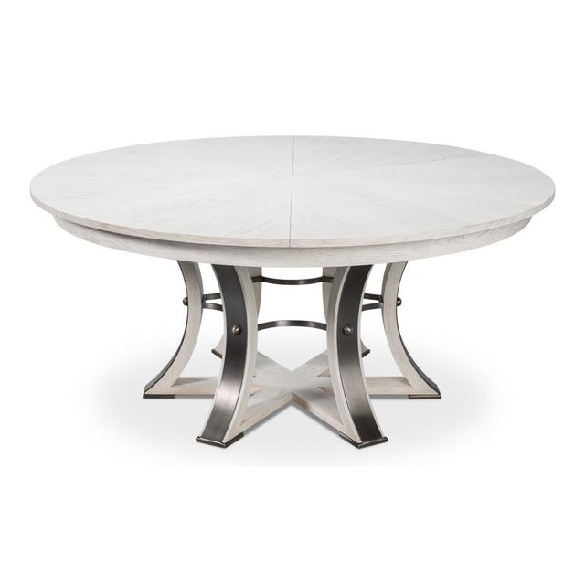 With its pale oak top and dark hammered iron, this large round dining table has a light, transitional look. The Working...
