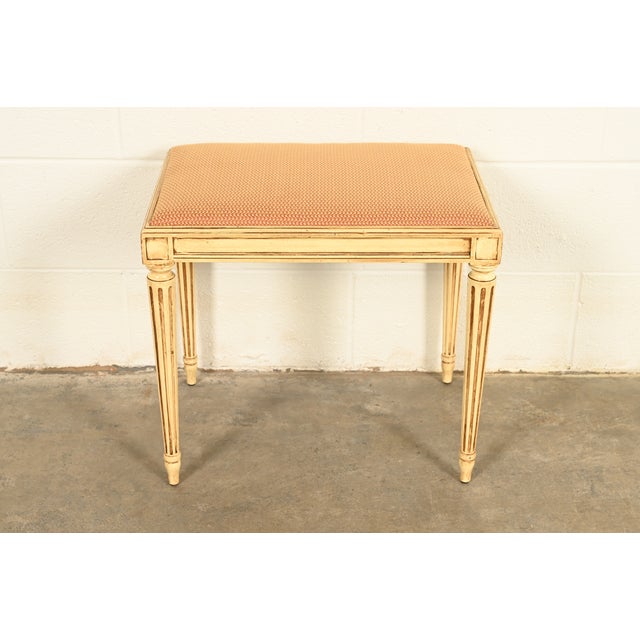 A gorgeous French Regency Louis XVI style vanity stool or ottoman By Drexel USA, Circa 1950s Cream lacquered solid...