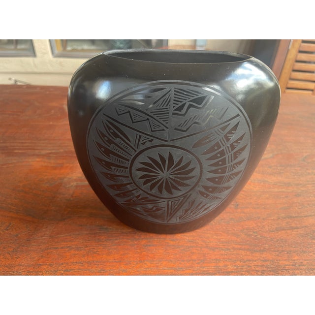 Yes, this is a stunning example of black-on-black etched pottery handcrafted by renowned Diné (Navajo) artist Marvin...
