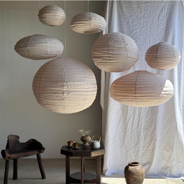 Large oval pendant light in a flattened pinkish-brown Japanese style, crafted from rattan and natural linen. Beautifully...