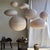 Large oval pendant light in a flattened pinkish-brown Japanese style, crafted from rattan and natural linen. Beautifully...