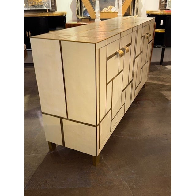 Rare Italian Mid-century designer textured laminate and brass inlaid cabinet. Italian Mid-Century designer cabinets with...