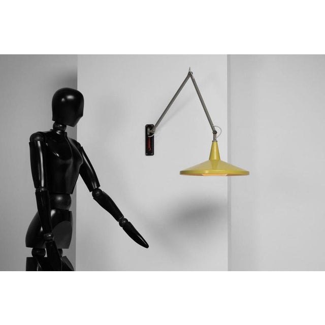 This panama wall lamp is a refined example of dutch postwar industrial design, where clarity of form and intelligent...