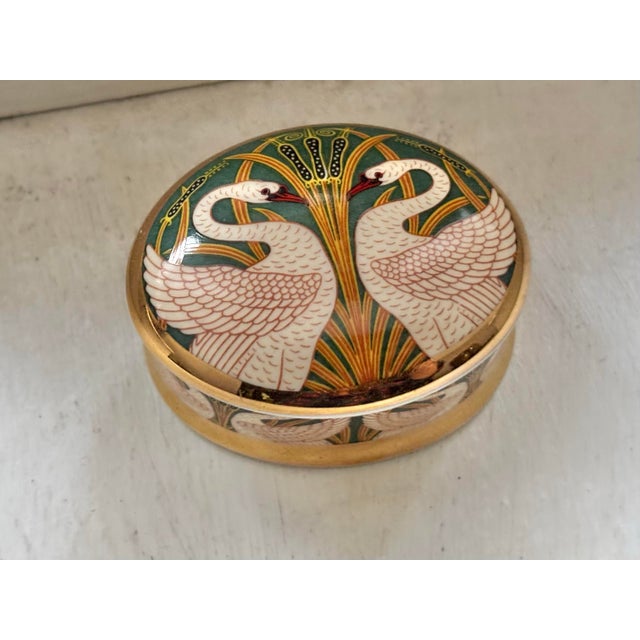 Produced in Staffordshire, England, this small lidded box has a stunning Art Nouveau swans and bulrushes motif. Made of...