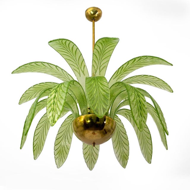 Mouth blown murano glass chandelier, green murano glass leaves, brass frame, three bulbs. The chandelier reproduces the...
