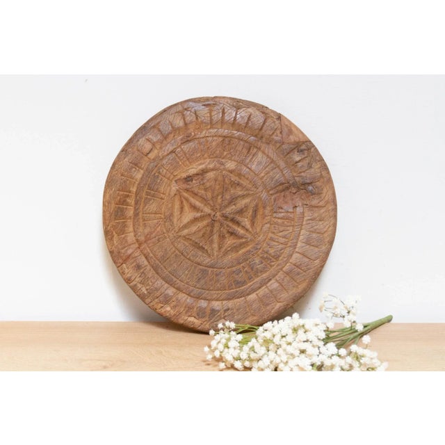This finely carved vintage chapati plate, handcrafted from wood, brings a touch of global charm to your home. Originally...