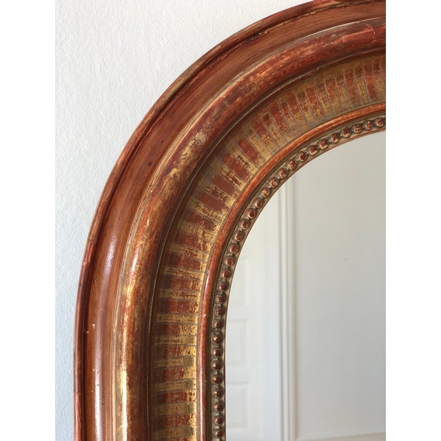 Antique French Louis Philippe mirror, dating to the late 19th century. The mirror features a giltwood frame with a warm,...