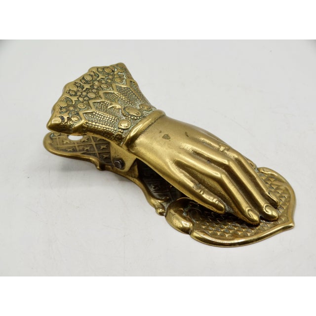 English Victorian era brass note or letter desk clip formed as a figural hand. It has a decorative cuff and a hole so that...