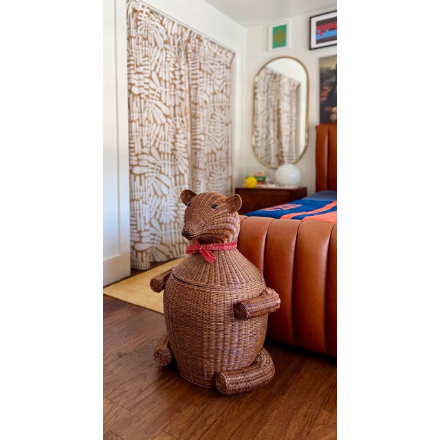 We are very pleased to offer this charming sculptural wicker bear storage basket, circa late 20th century, beautifully...
