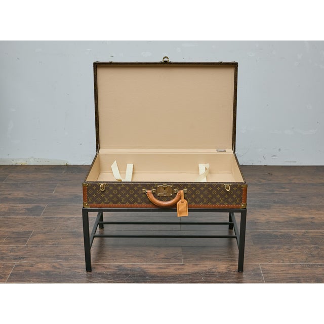A vintage Louis Vuitton trunk from the late 1970s to early 1980s finds new life as a distinctive coffee table, seamlessly...