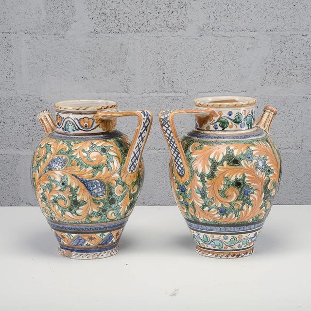 This pair of majolica apothecary jars, dating from the mid-20th century and produced in Deruta, masterfully recreates the...