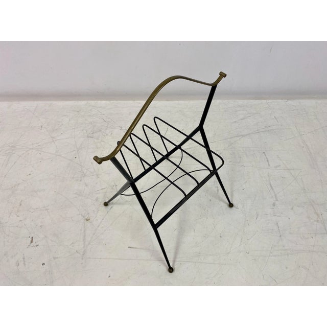 Magazine rack Black painted metal frame Patterned brass handle top Brass ball feet Italy 1960s