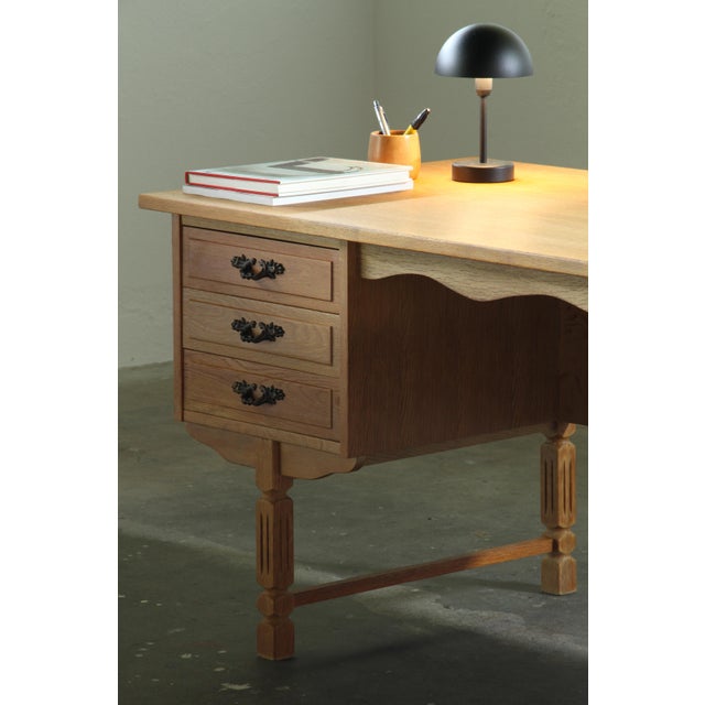 A freestanding brutalist desk attributed to Danish designer Henning Kjærnulf, made in Denmark circa 1960. Built from oak...