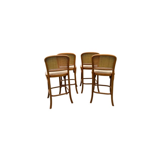 Set of 4 vintage barstools made of beach wood and oak framing with upholstered seats and hand woven cane backing.