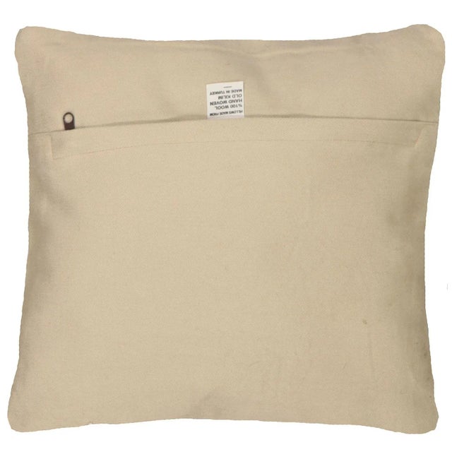 This pillow is made with a vintage handwoven Turkish Mid-Century rug fragment. It has a cotton back and a zipper closure....