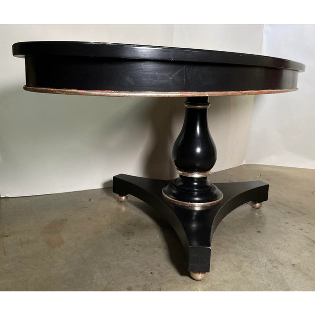 This Transitional Black Elliptical Table with Silver Leaf Trim was handcrafted in house by Kipper himself. Has red rub...