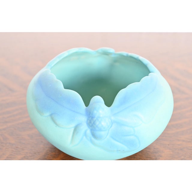 A gorgeous Arts & Crafts period turquoise glazed ceramic art pottery bowl with oak leaf and acorn motif By Van Briggle...