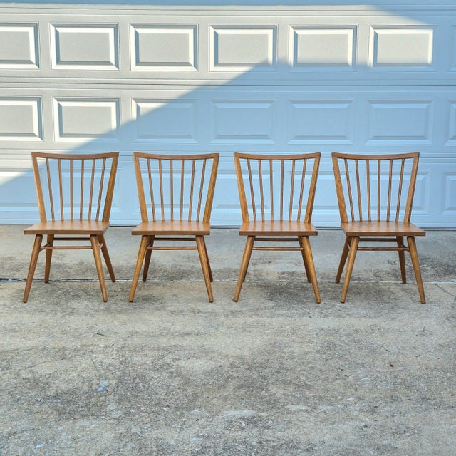 This is a set of 4 vintage MCM dining chairs by Russel Wright for Conant Ball. The chairs are made of solid birch wood in...