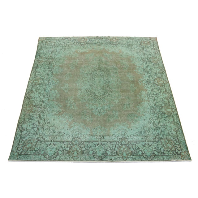 This green, antique, hand-knotted Persian wool rug has a medallion floral design and gray accents. This rug measures...