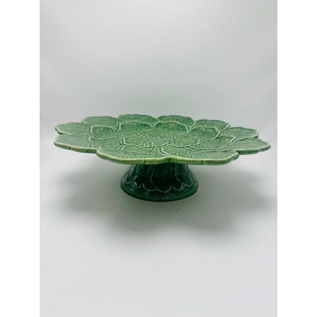 This is a Bordallo Pinheiro ceramic pedestal plate or compote dish, made in Portugal. It features the brand’s signature...