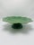 This is a Bordallo Pinheiro ceramic pedestal plate or compote dish, made in Portugal. It features the brand’s signature...