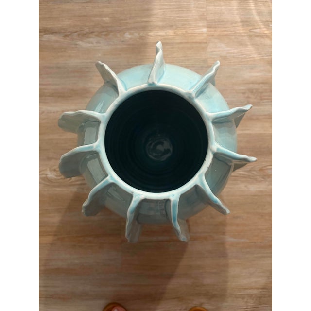 Crimped ceramic ribbons that are hand-applied create the artistic interest in this vase.