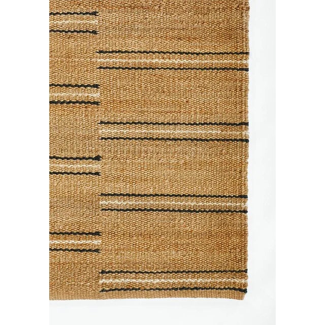 This handwoven black and white striped jute rug from the Crescent Collection is a natural beauty. A fresh take on a more...