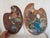 A pair of vintage wood artists palettes. Both have paint on the surface, one is two sided.