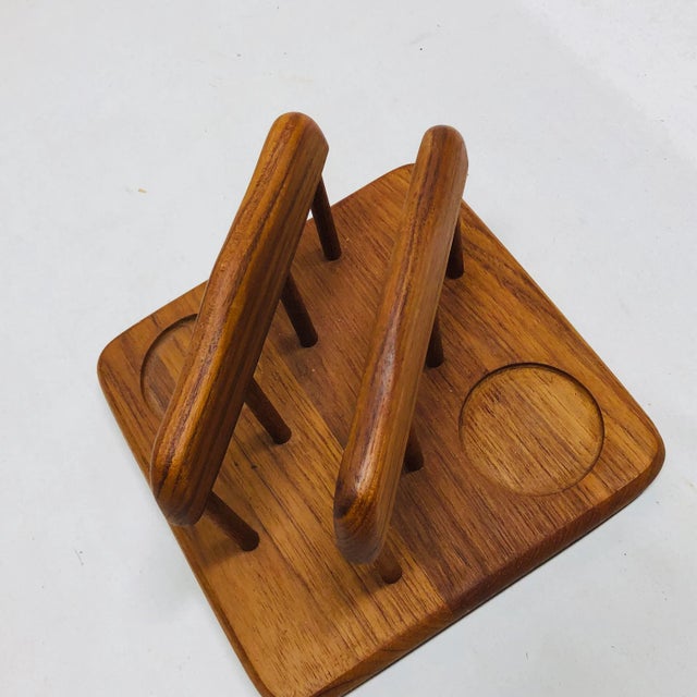 Mid Century teak napkin holder with slots for salt and pepper shakers. S &P slots are round and measure 2” diameter....