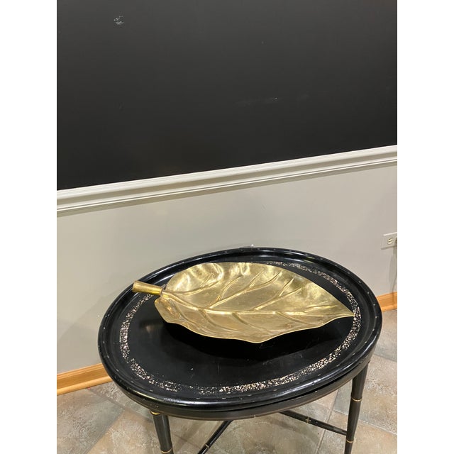 A 24-inch long dish shaped in the form of a stylized leaf with detailed veining. Finished in a reflective gold-tone...