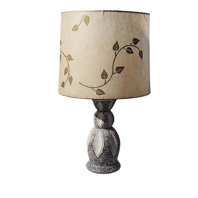 Lovely mid century modern table lamp with shade, in excellent working condition. Textured ceramic body in gray and whte...